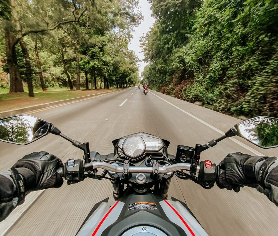 man riding motorcycle on road during daytime